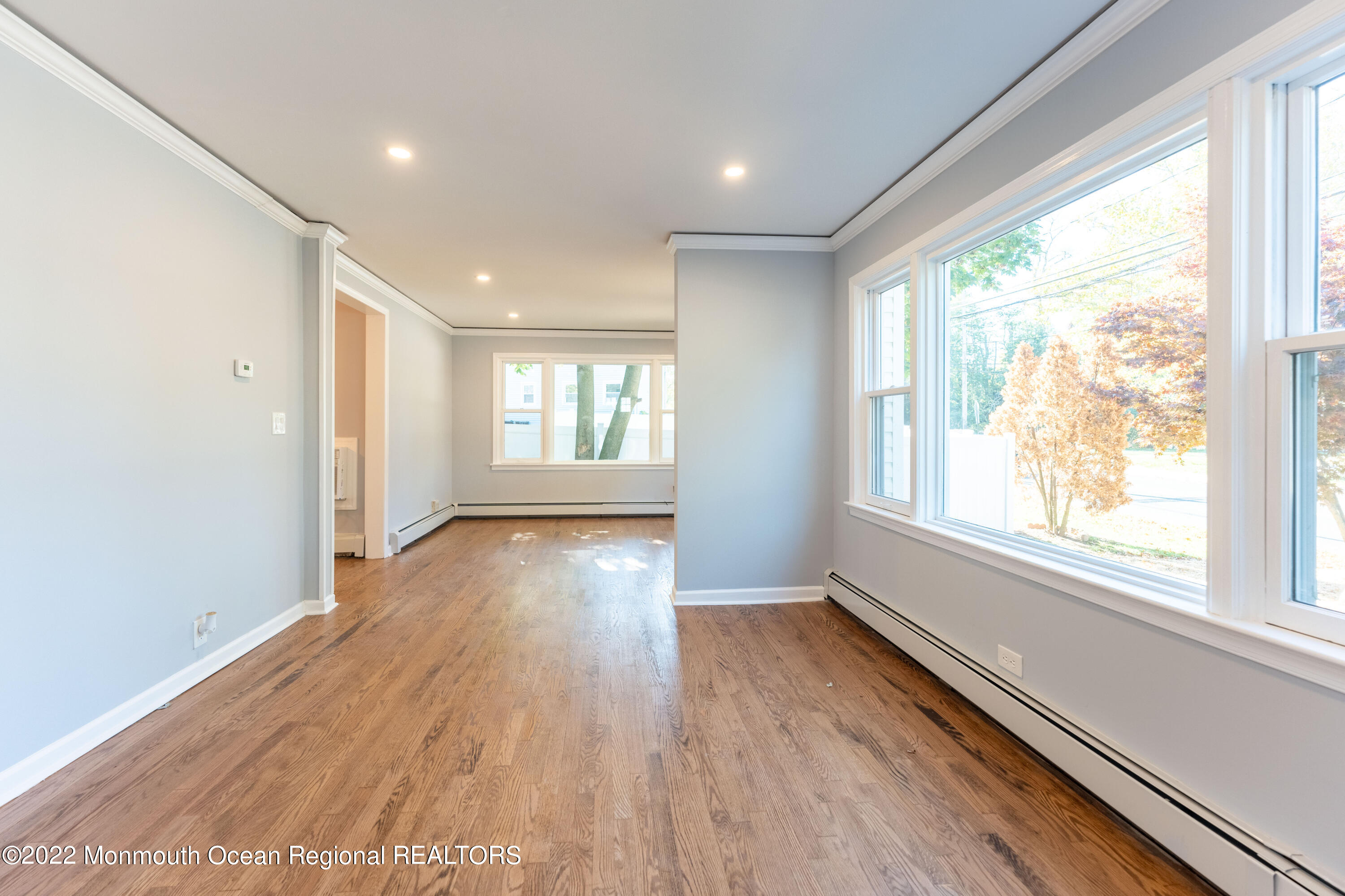 397 E Road Belford, NJ 07718 - Photo 5 of 34 a view of an empty room with wooden floor and a window