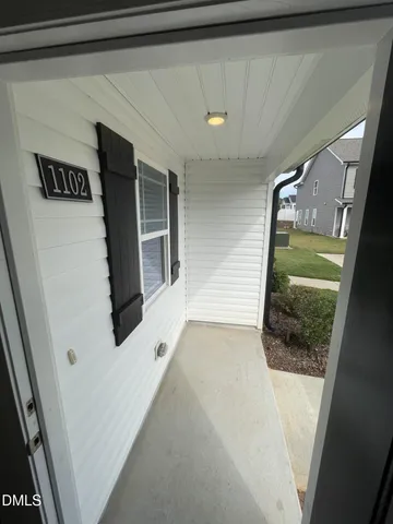 a view of a hallway with washer and dryer