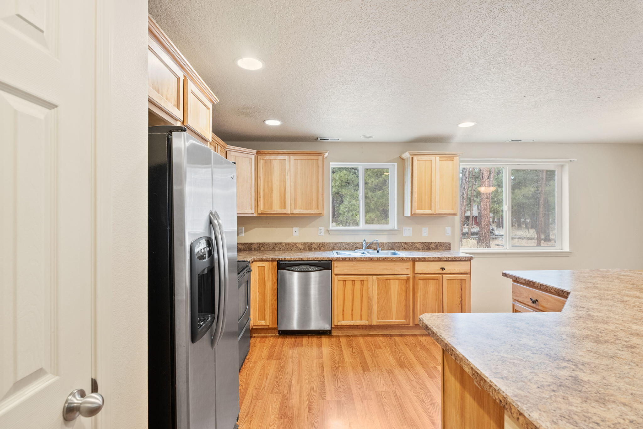 59674 Navajo Road Bend, OR 97702 - Photo 12 of 47 Kitchen area with island, pantry, and stainless steel appliances.