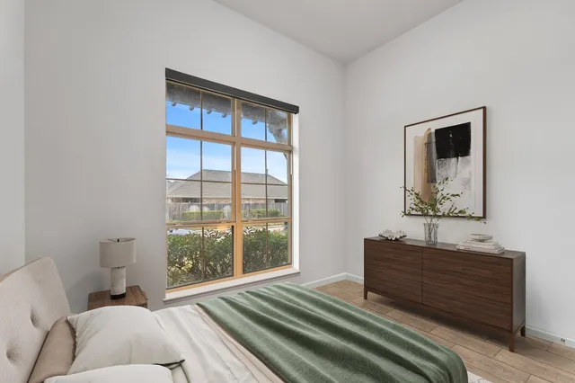 a bedroom with a bed and a window