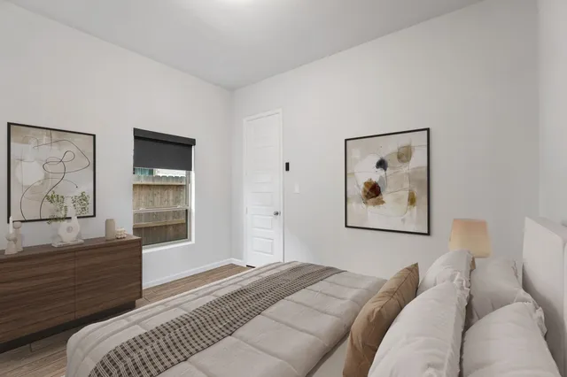 a bedroom with a bed and a window