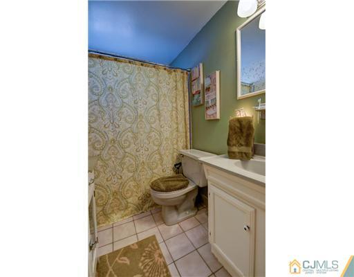 77 Westminster Road Colonia, NJ 07067 - Photo 5 of 8 a bathroom with a toilet and a shower