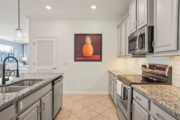 a kitchen that has a sink and a stove