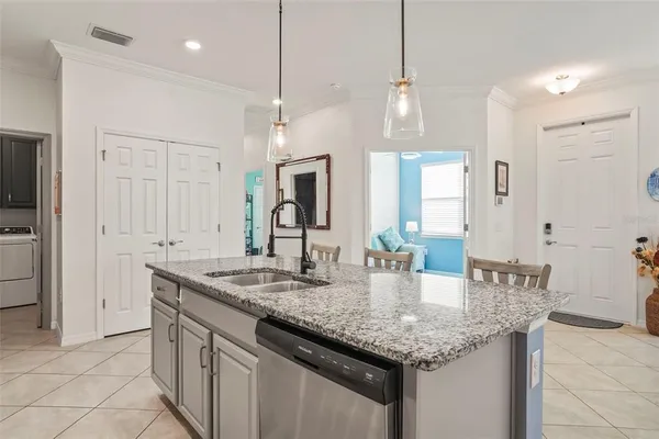a kitchen with center island a sink stainless steel appliances and cabinets