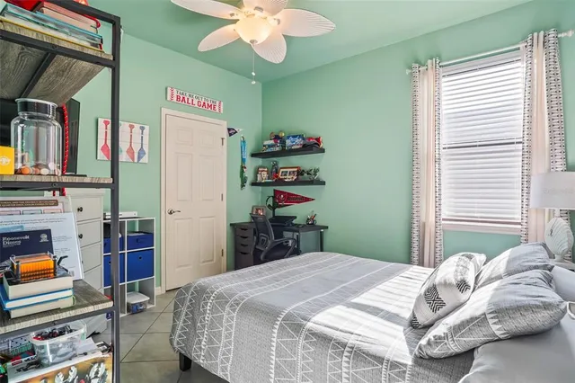 a bedroom with bed and a chandelier