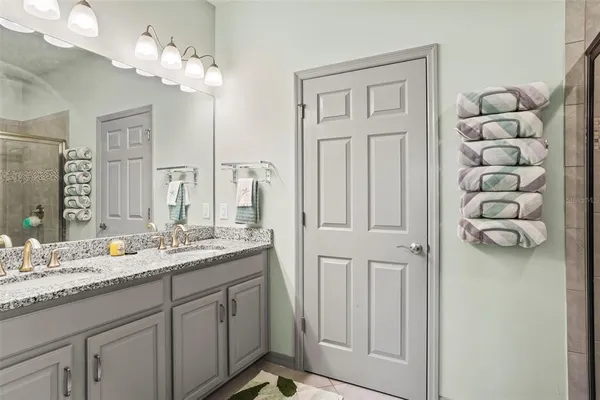 a bathroom with a double vanity sink mirror and