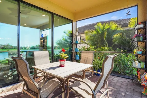 a view of an outdoor dining space with a table and chairs