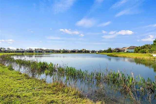 a view of a lake with houses in the back