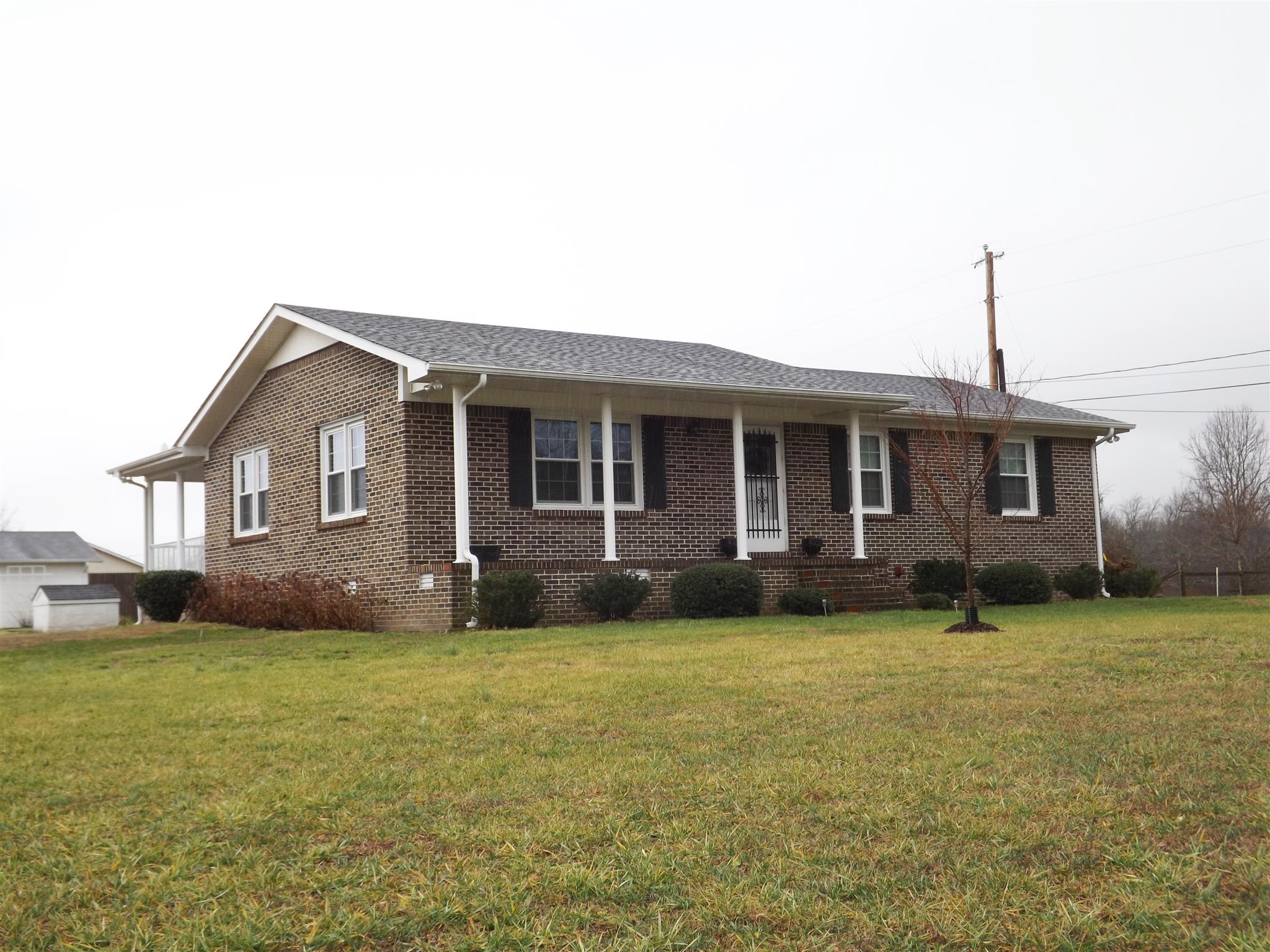 1445 Summitville Road Manchester, TN 37355 - Photo 1 of 22 a front view of a house with a garden