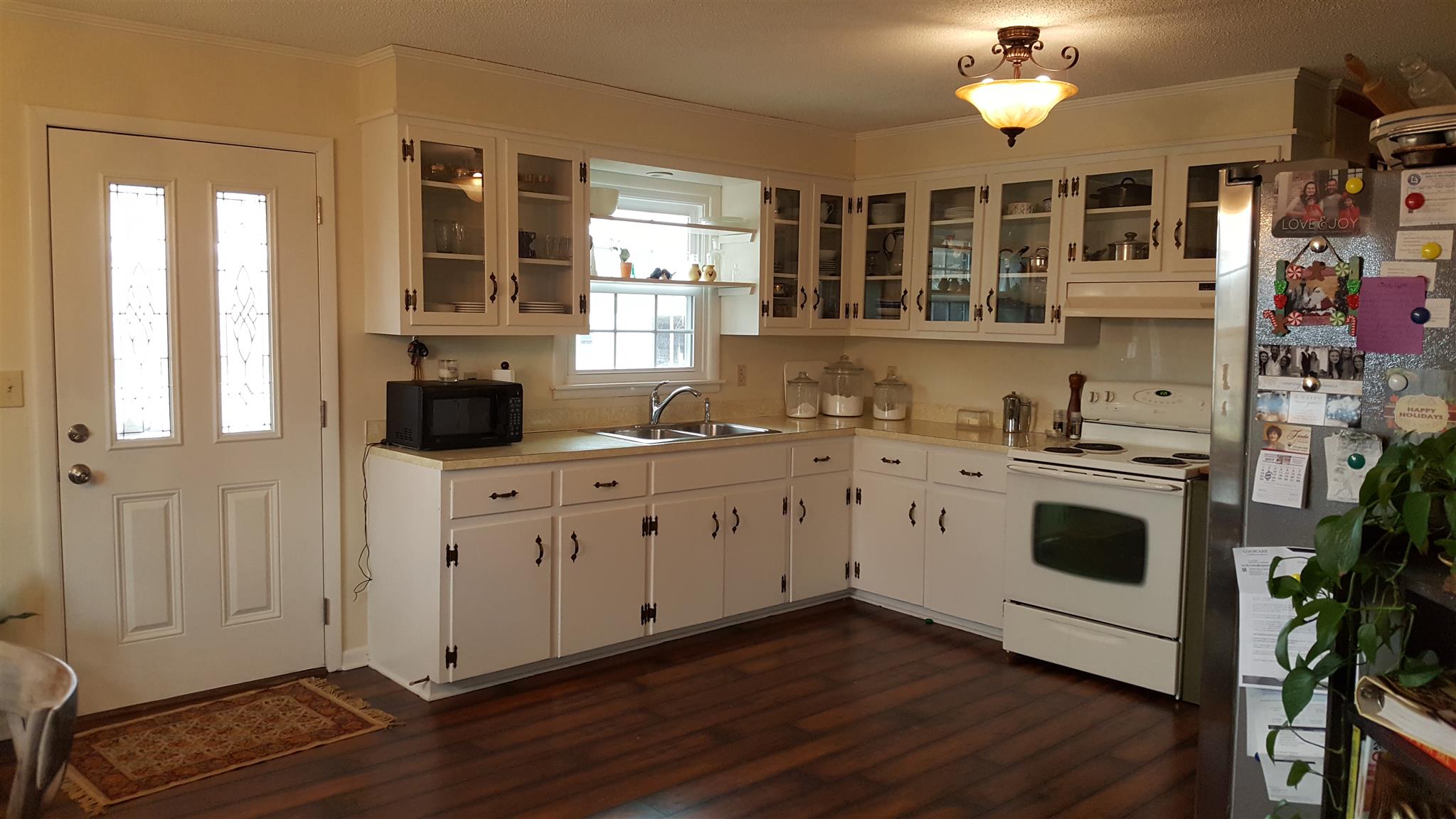 1445 Summitville Road Manchester, TN 37355 - Photo 12 of 22 a kitchen with stainless steel appliances white cabinets and wooden floors