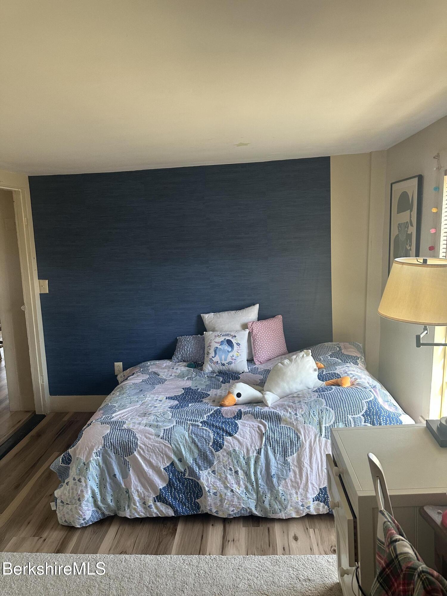27 North Main Road Otis, MA 01253 - Photo 13 of 24 a bedroom with a bed and lamp