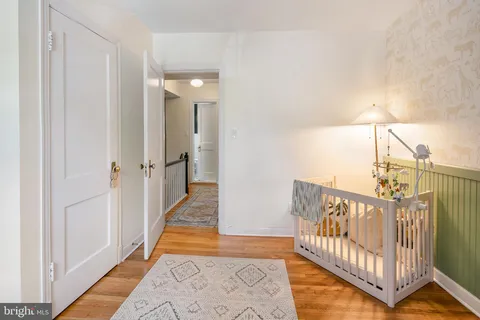 a view of a hallway with a livingroom and stairs