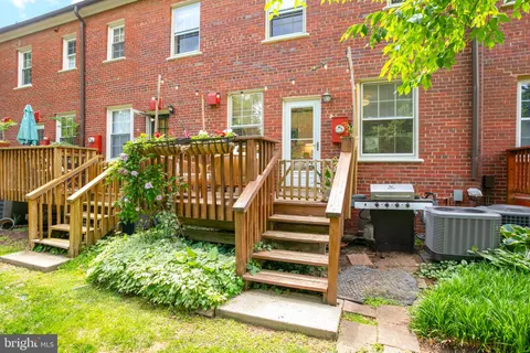 a view of a house with a small yard and wooden fence