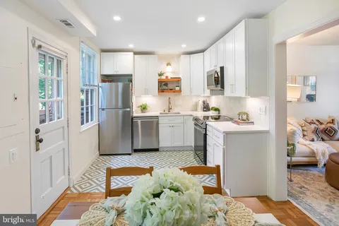 a kitchen with stainless steel appliances granite countertop a refrigerator and a sink