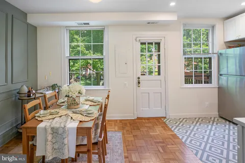 a view of a dining room with furniture and windows