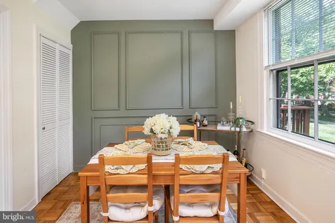 a view of a dining room with furniture and window