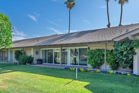 a view of a house with a yard and plants