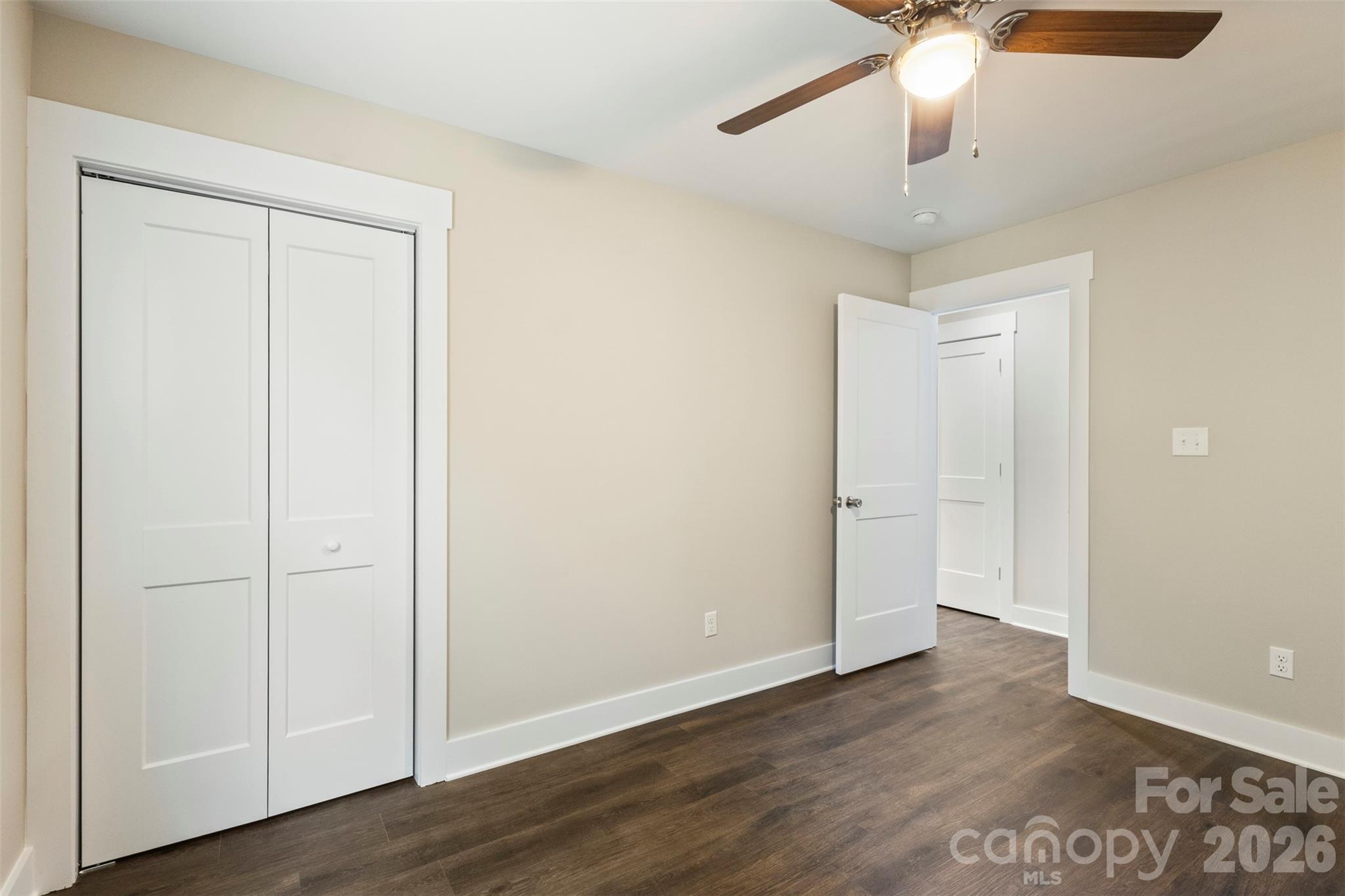 316 Union Street Maiden, NC 28650 - Photo 12 of 21 an empty room with wooden floor closet and windows