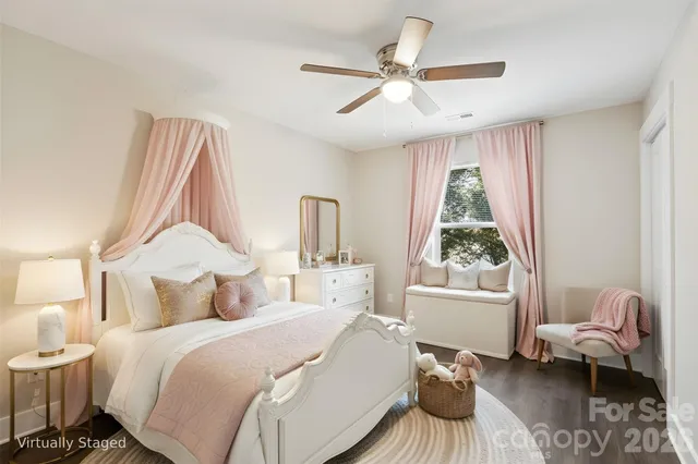 a bedroom with a bed couch and window