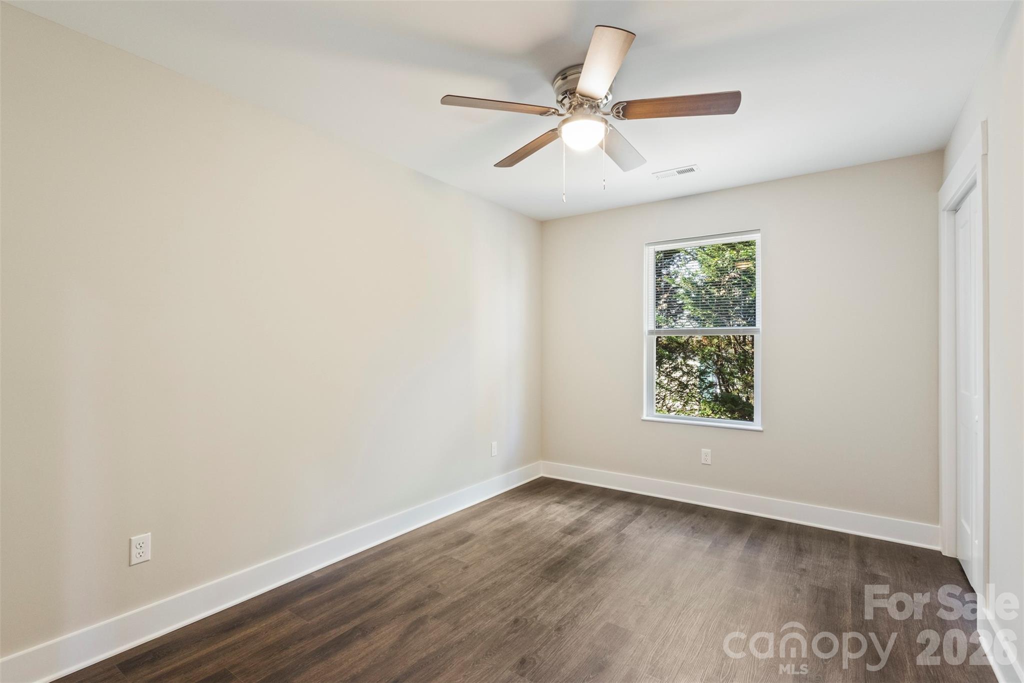 316 Union Street Maiden, NC 28650 - Photo 20 of 23 an empty room with wooden floor fan and windows