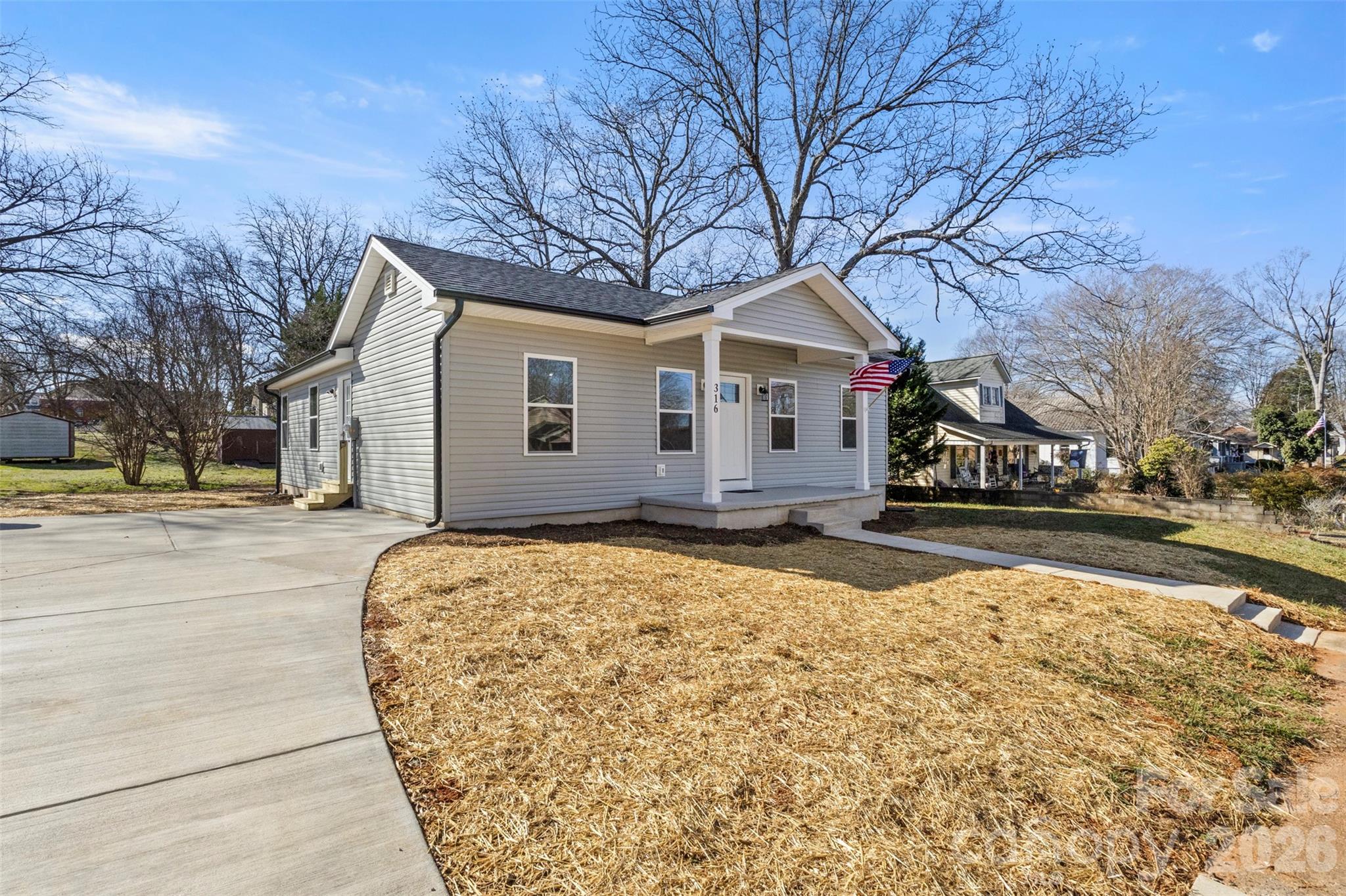 316 Union Street Maiden, NC 28650 - Photo 2 of 21 a front view of a house with a yard covered in snow