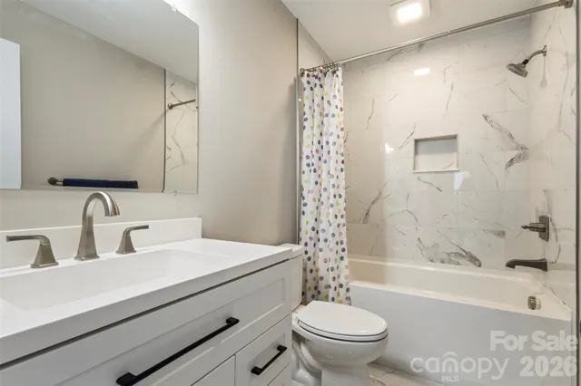 a bathroom with a sink a toilet and a bathtub