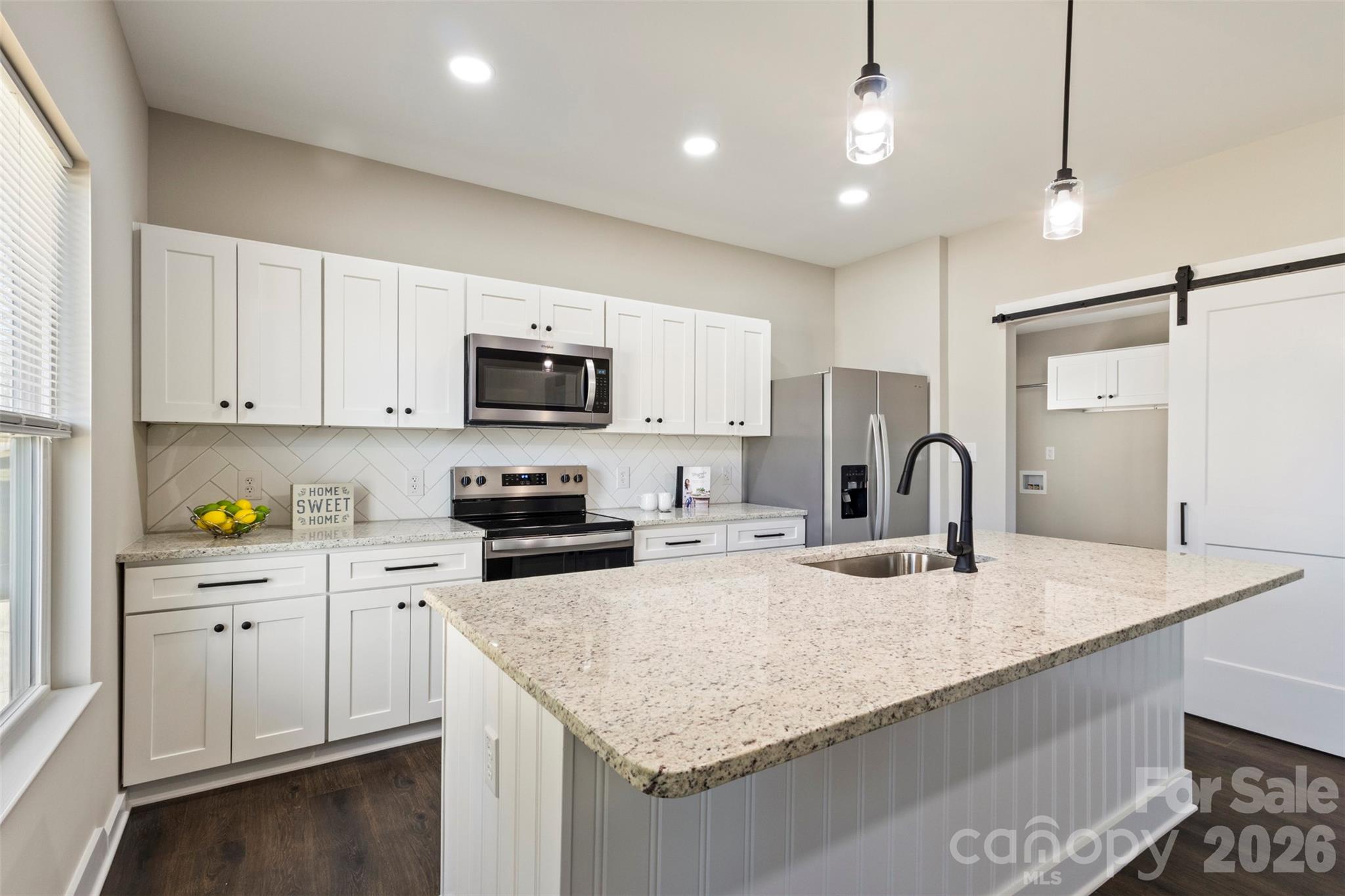 316 Union Street Maiden, NC 28650 - Photo 5 of 21 a kitchen with granite countertop a sink a counter top space appliances and cabinets