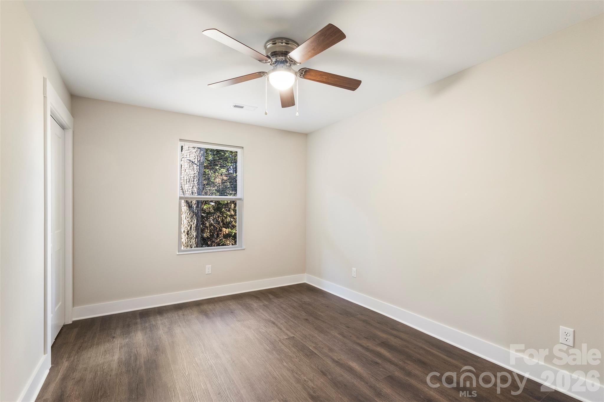316 Union Street Maiden, NC 28650 - Photo 8 of 21 an empty room with wooden floor and windows