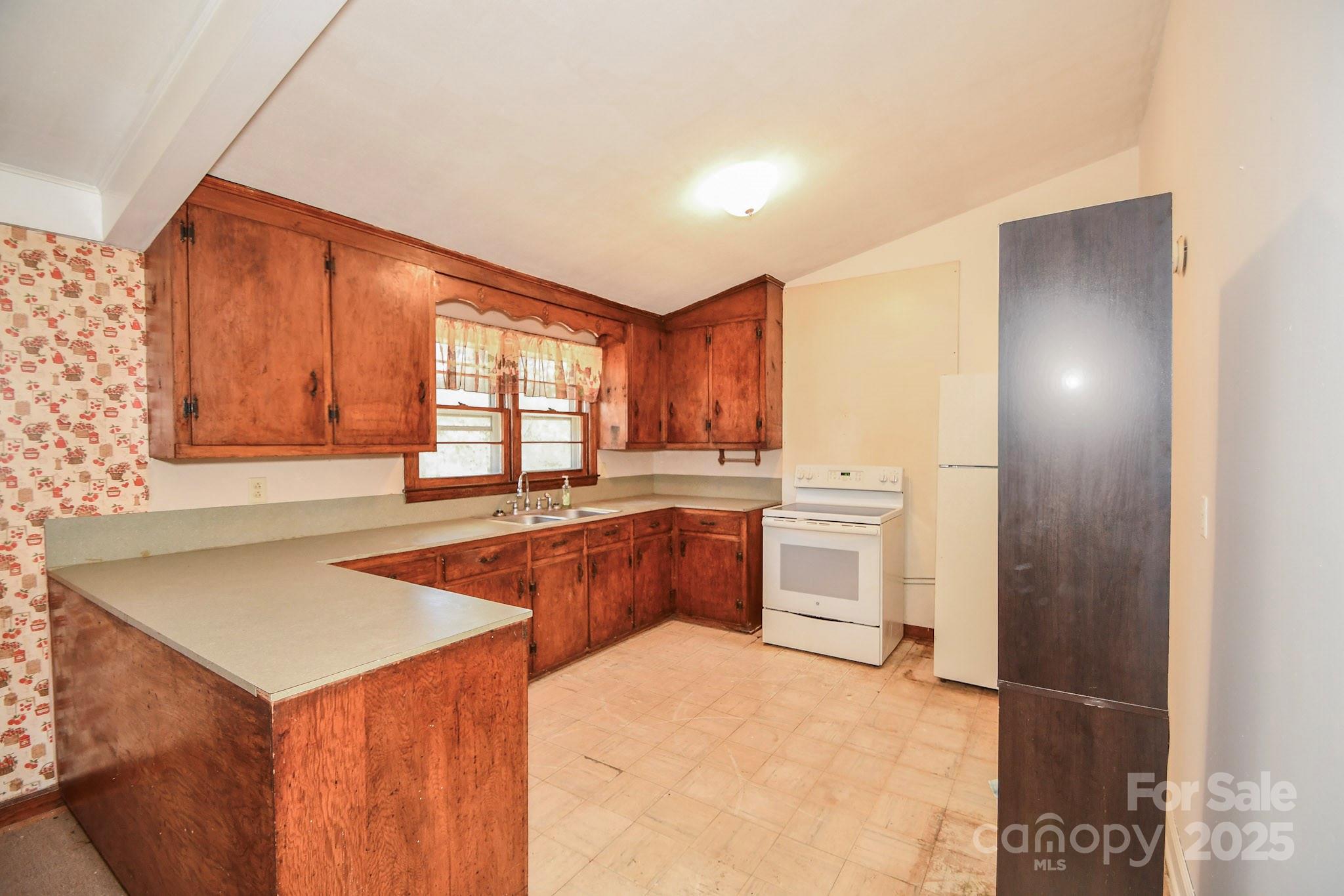 2922 Joe Griffin Road Monroe, NC 28112 - Photo 19 of 26 a kitchen with stainless steel appliances granite countertop a sink and cabinets with wooden floor