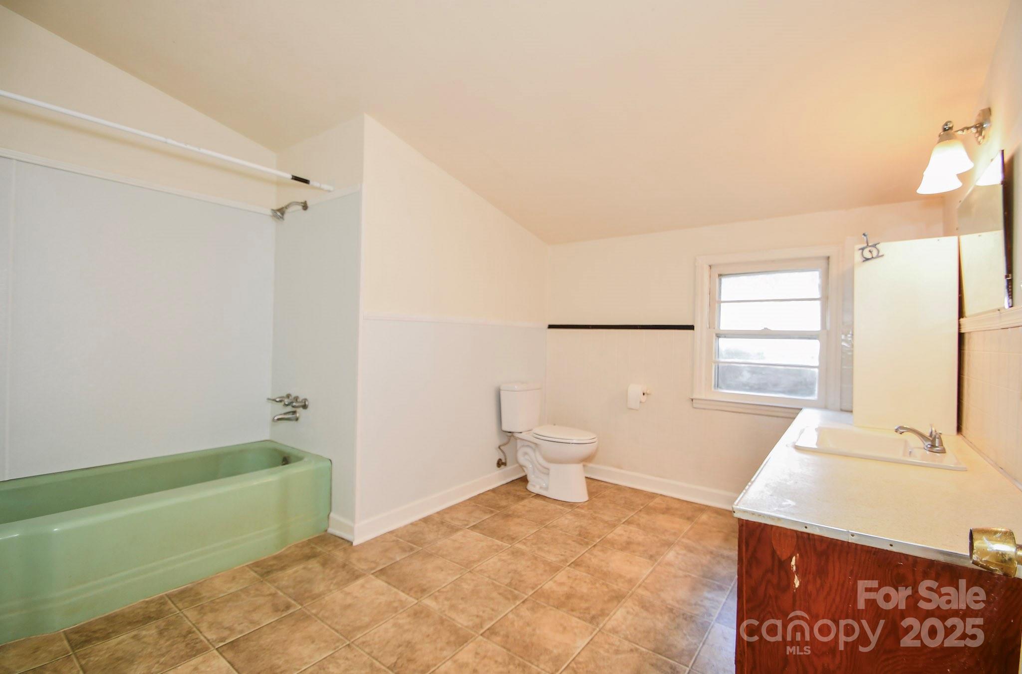 2922 Joe Griffin Road Monroe, NC 28112 - Photo 24 of 26 a bathroom with a sink a toilet and tub