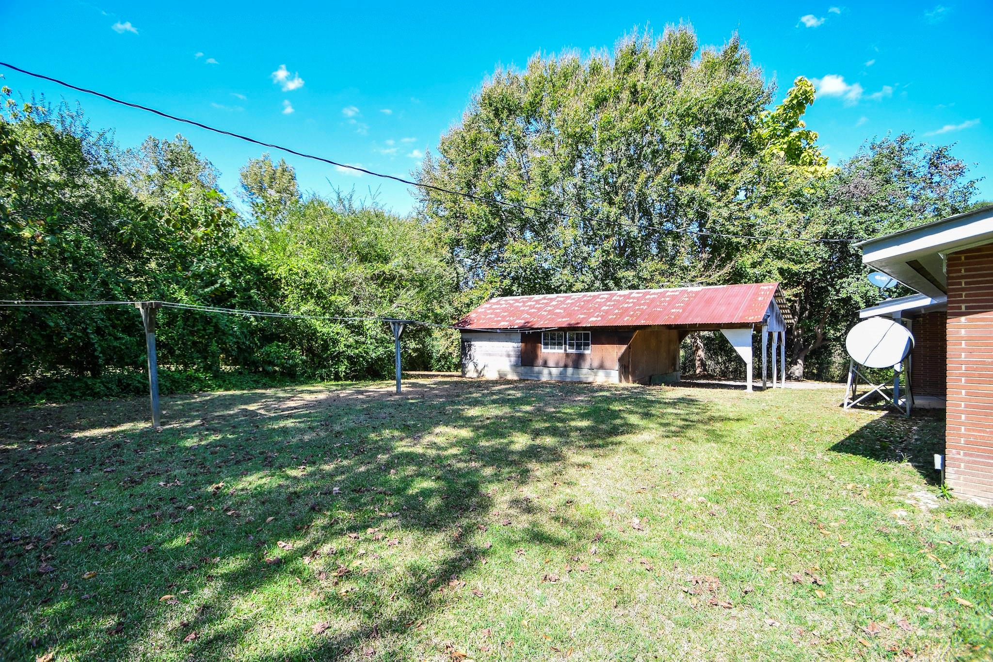 2922 Joe Griffin Road Monroe, NC 28112 - Photo 5 of 26 a backyard of a house with table and chairs