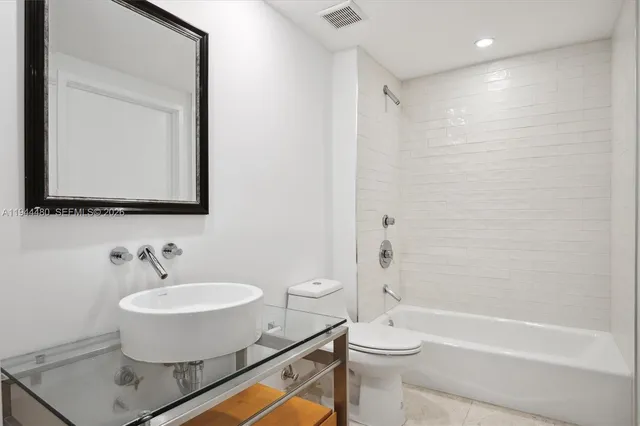 a bathroom with a toilet a sink and bathtub