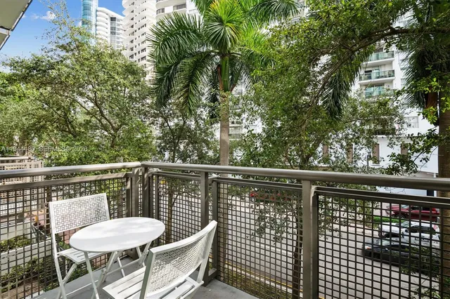a balcony with table and chairs