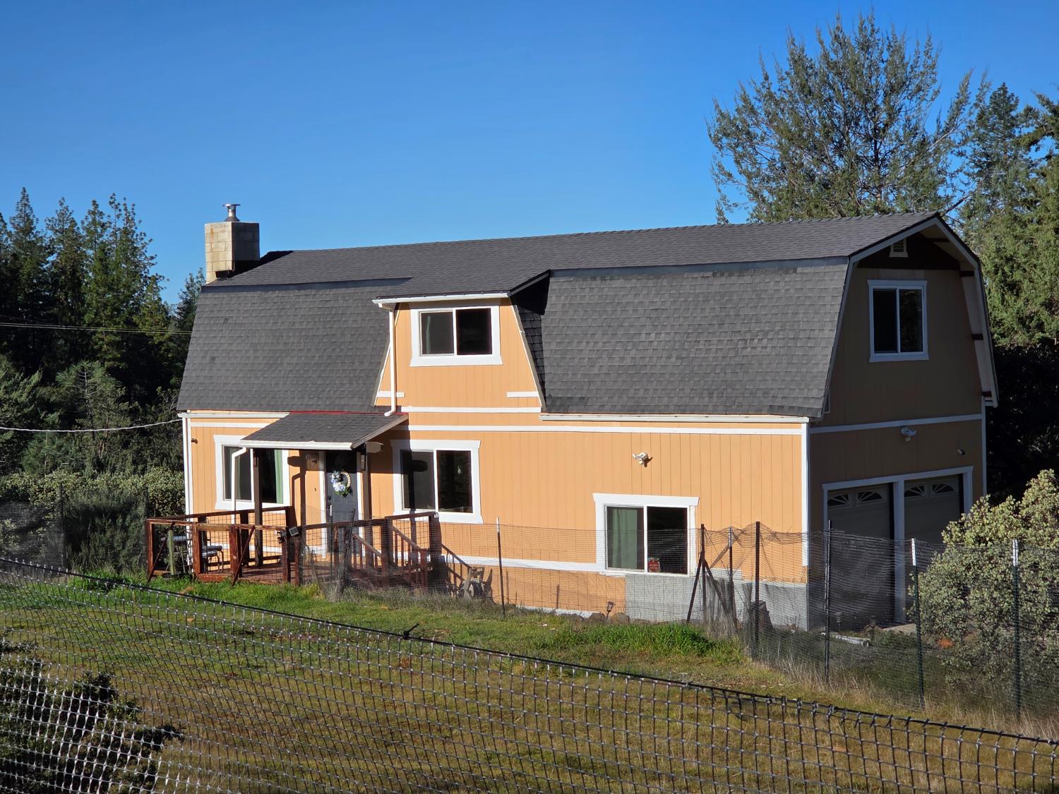 a house that has a tree in front of it