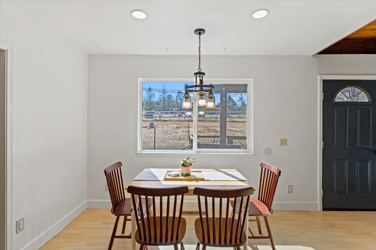 10402 Newtown Road Nevada City, CA 95959 - Photo 13 of 44 a view of a dining room with furniture window and wooden floor
