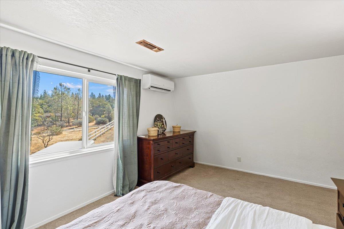 10402 Newtown Road Nevada City, CA 95959 - Photo 19 of 44 a bedroom with a bed and a window