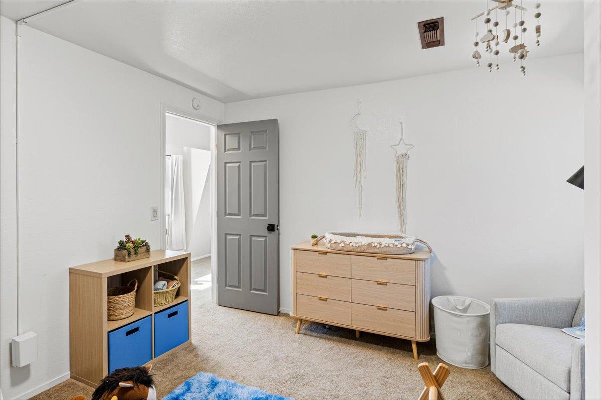10402 Newtown Road Nevada City, CA 95959 - Photo 21 of 44 a room with a baby crib and a dresser