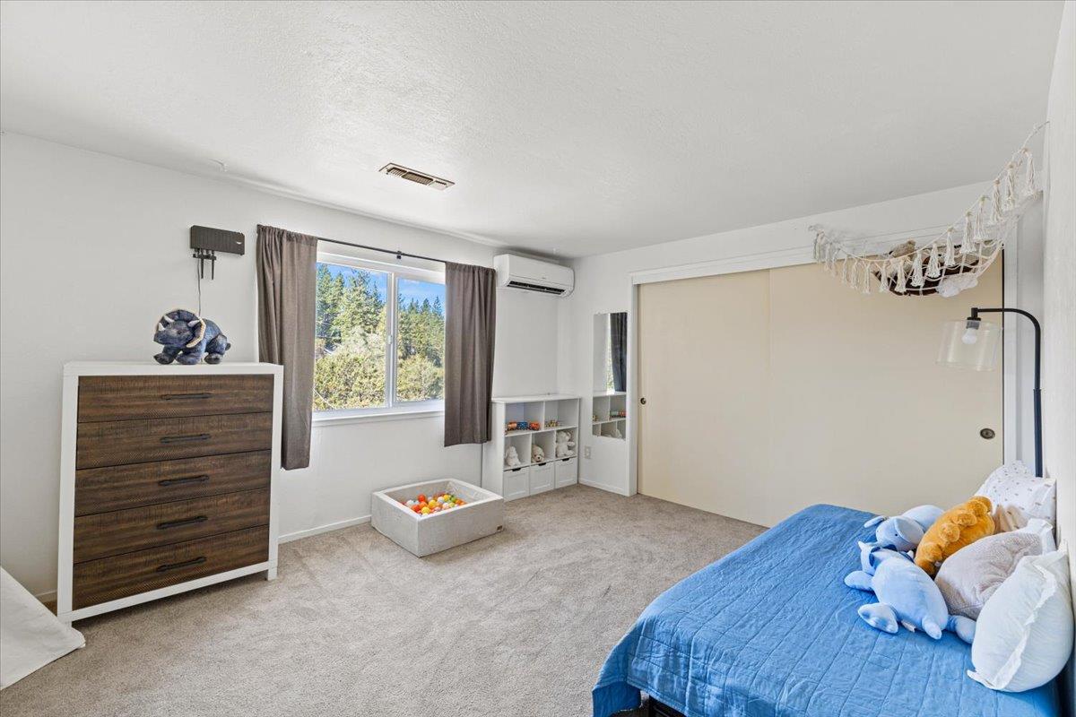 10402 Newtown Road Nevada City, CA 95959 - Photo 22 of 44 a bedroom with a bed and a window