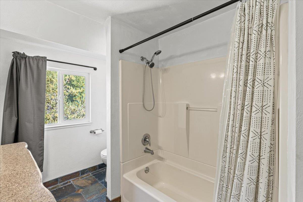 10402 Newtown Road Nevada City, CA 95959 - Photo 26 of 44 a bathroom with a tub shower and a sink