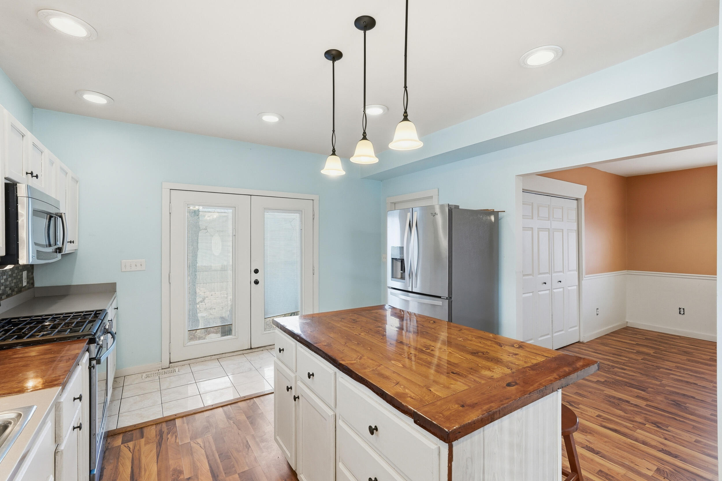 122 9th Street Southwest De Motte, IN 46310 - Photo 11 of 29 a kitchen with kitchen island a counter top space a sink stainless steel appliances and cabinets
