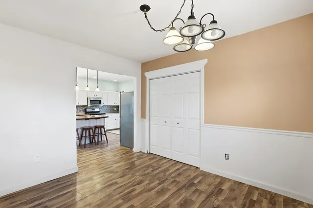 a view of a room with wooden floor and workspace