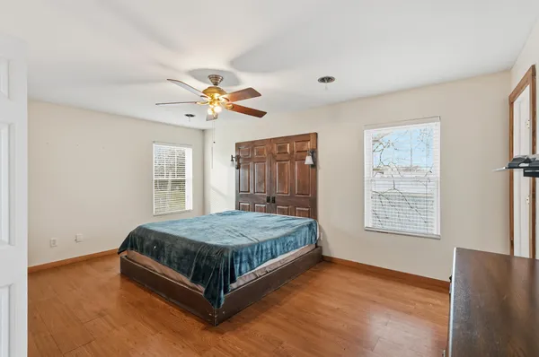 a bedroom with a bed dresser and a window