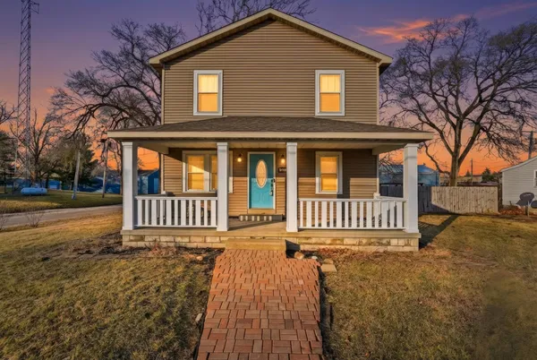 a view of a house with a yard and deck