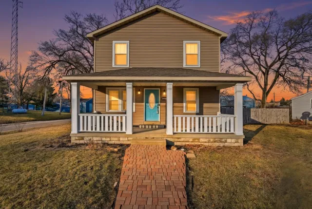 a view of a house with a yard and deck