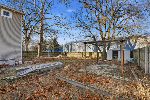 a backyard of a house with a table and chairs