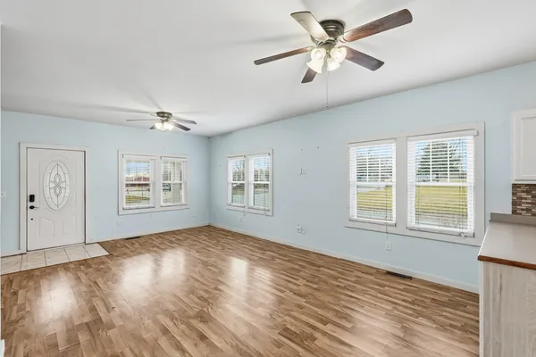 wooden floor in an empty room with a window