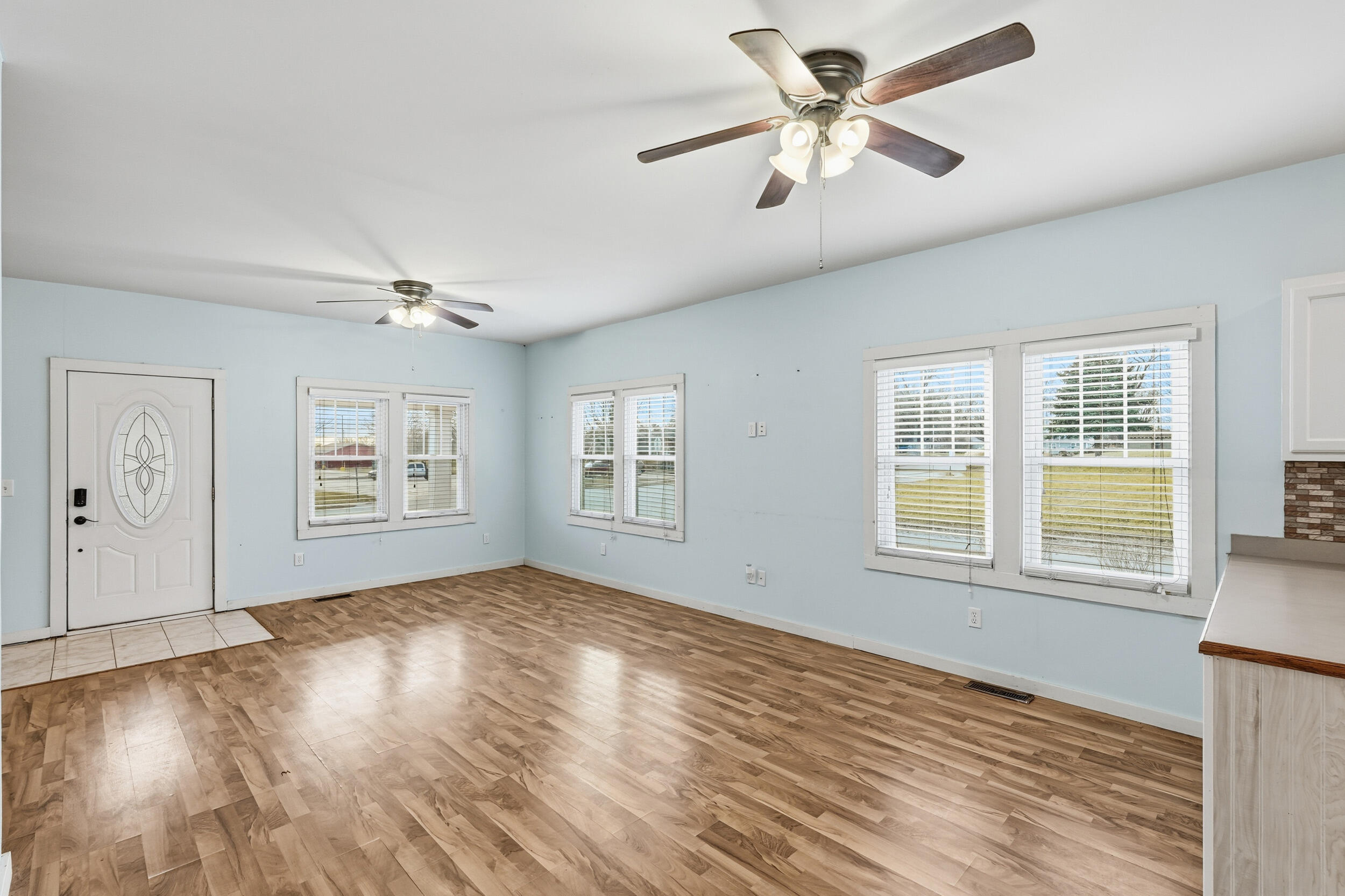 122 9th Street Southwest De Motte, IN 46310 - Photo 6 of 29 wooden floor in an empty room with a window