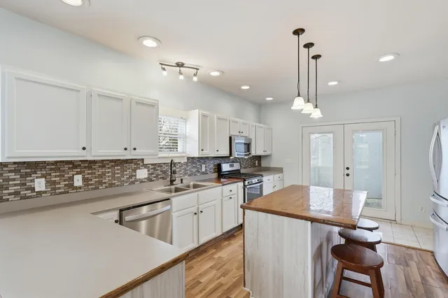 a kitchen with a sink appliances and cabinets