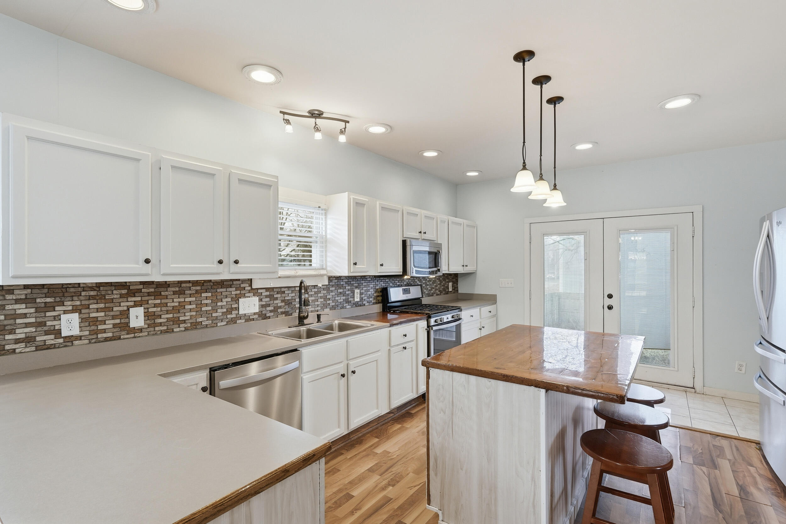 122 9th Street Southwest De Motte, IN 46310 - Photo 7 of 29 a kitchen with a sink appliances and cabinets