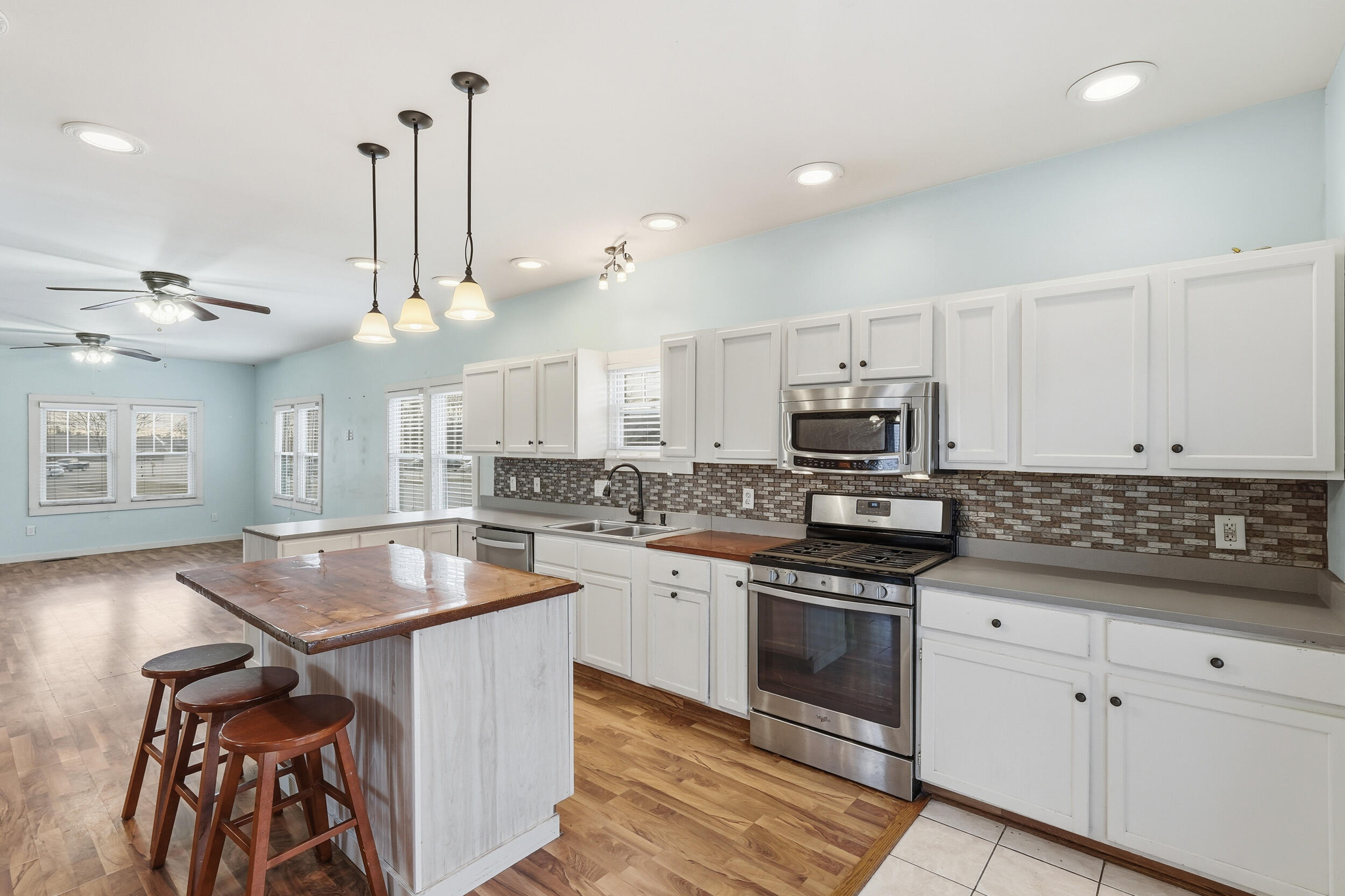 122 9th Street Southwest De Motte, IN 46310 - Photo 9 of 29 a kitchen with stainless steel appliances granite countertop a stove a sink and a refrigerator